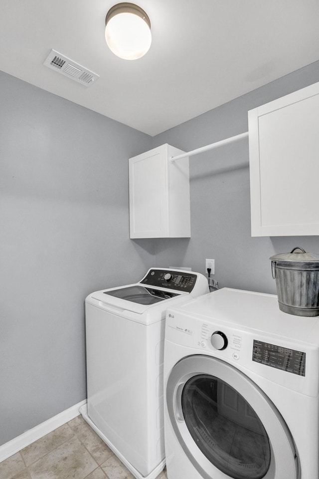 114 Suggs Dr, Lebanon, TN 37087 - clothes washing area featuring visible vents, light tile patterned flooring, washer and dryer, baseboards, and cabinet space