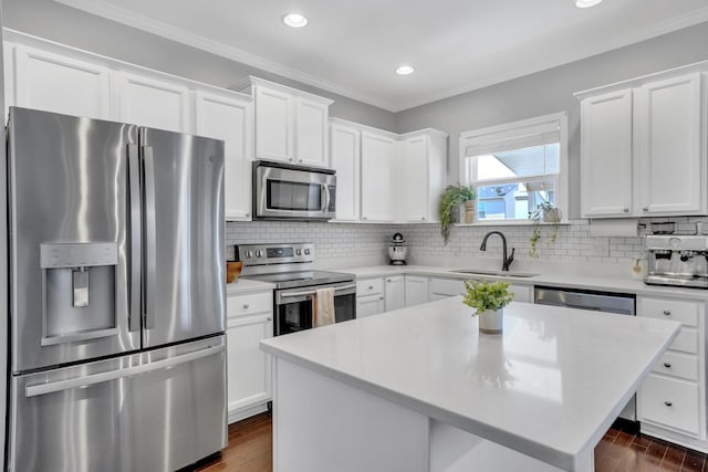 114 Suggs Dr, Lebanon, TN 37087 - kitchen featuring dark wood-style floors, backsplash, white cabinets, appliances with stainless steel finishes, and a sink