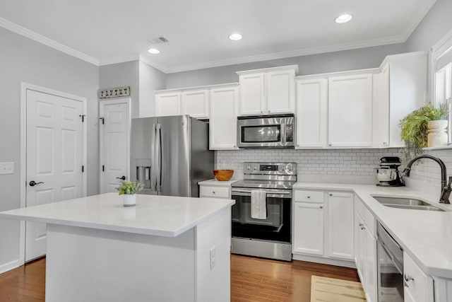 114 Suggs Dr, Lebanon, TN 37087 - kitchen with a sink, appliances with stainless steel finishes, wood finished floors, and white cabinetry