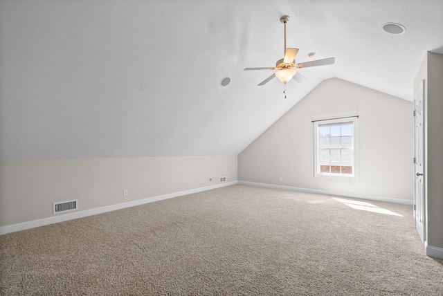 additional living space featuring baseboards, carpet floors, visible vents, lofted ceiling, and ceiling fan