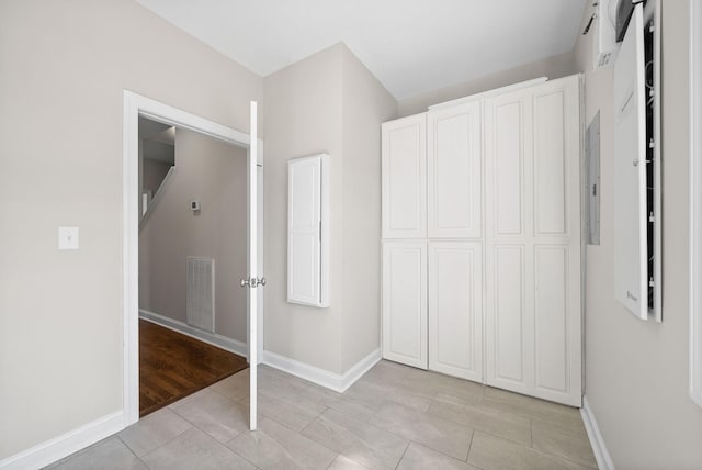 unfurnished bedroom with a closet, baseboards, and visible vents
