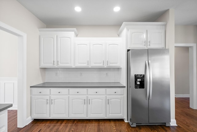 kitchen with stainless steel fridge with ice dispenser, decorative backsplash, white cabinetry, and dark wood finished floors