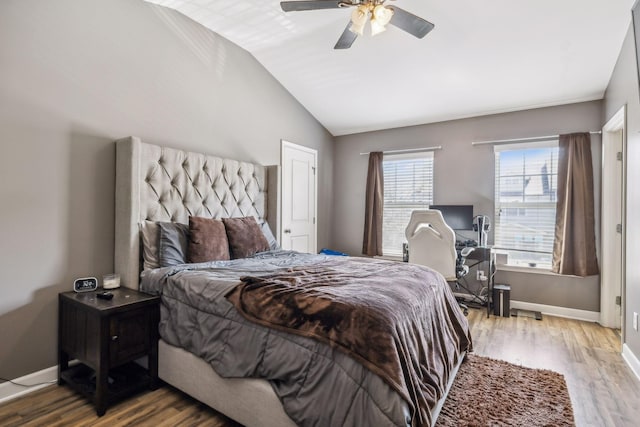 bedroom featuring vaulted ceiling, wood finished floors, a ceiling fan, and baseboards