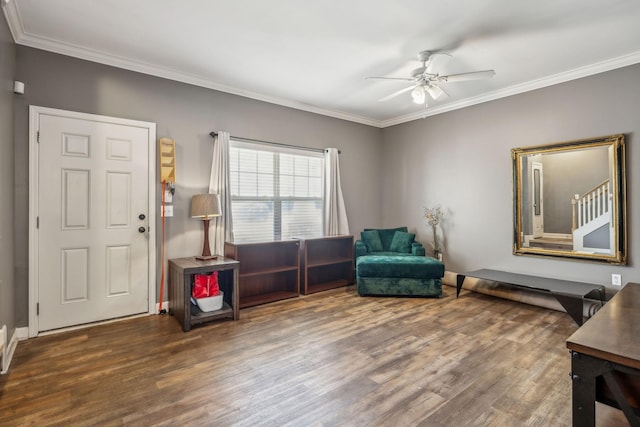 sitting room with crown molding, wood finished floors, and a ceiling fan