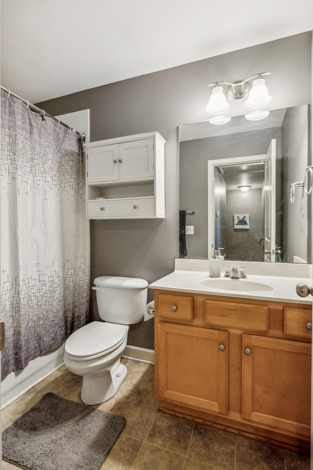 bathroom with vanity, toilet, baseboards, tile patterned flooring, and shower / bath combination with curtain