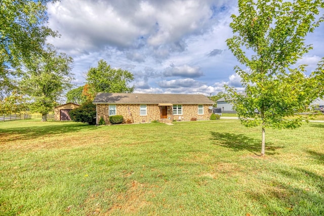 exterior space with an outdoor structure, stone siding, fence, and a lawn
