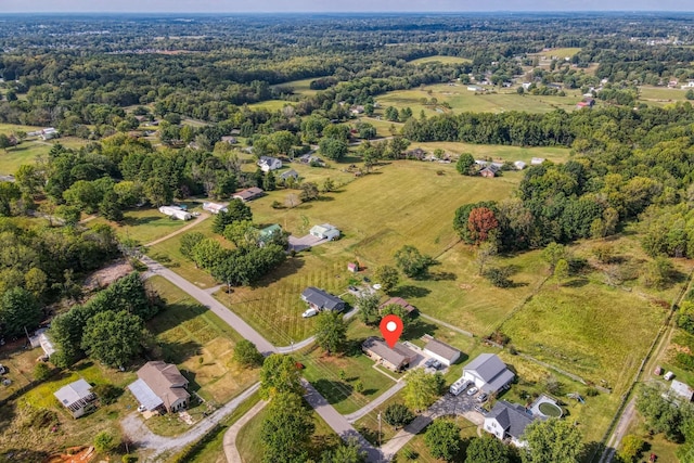 birds eye view of property with a view of trees
