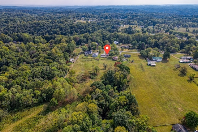 birds eye view of property with a view of trees