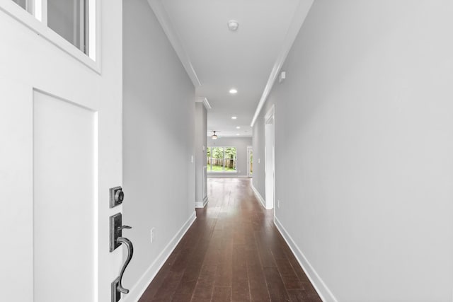 corridor featuring dark wood-style flooring, baseboards, recessed lighting, and crown molding