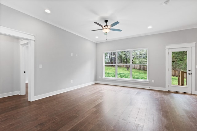 empty room with baseboards, a ceiling fan, dark wood finished floors, crown molding, and recessed lighting