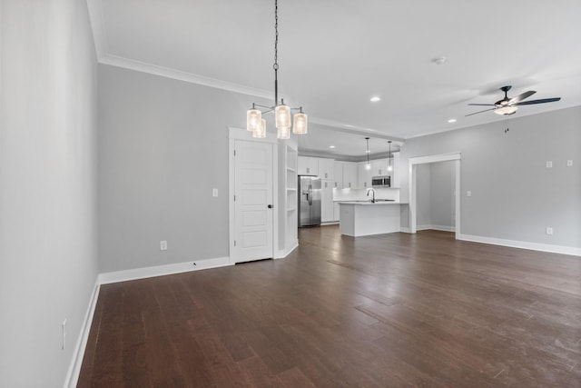 unfurnished living room featuring recessed lighting, dark wood-style floors, baseboards, and a ceiling fan