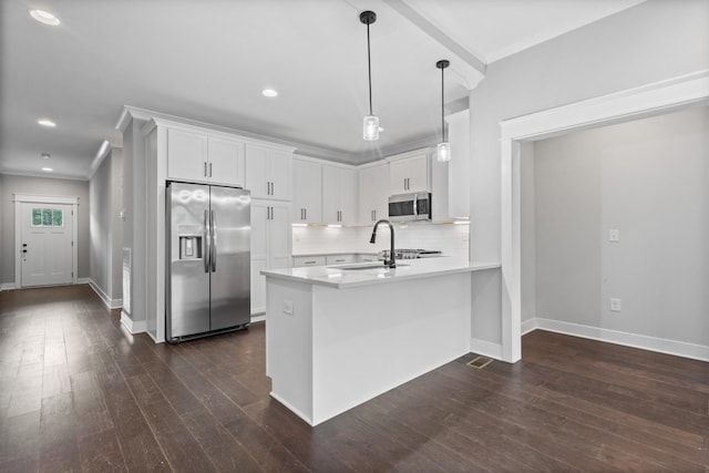 kitchen featuring tasteful backsplash, a peninsula, white cabinets, appliances with stainless steel finishes, and light countertops