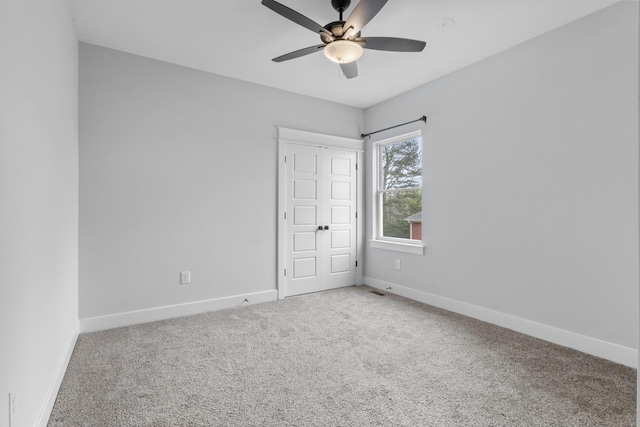 unfurnished bedroom featuring carpet floors, baseboards, and a ceiling fan