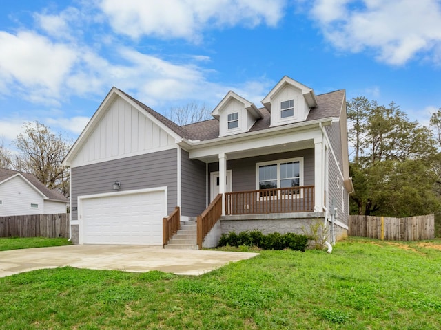 view of front of house with a front yard, a porch, fence, and driveway