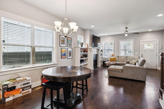 dining room with recessed lighting, baseboards, dark wood-style flooring, and ceiling fan with notable chandelier