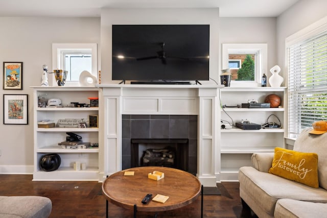living area with a fireplace and dark wood-style flooring