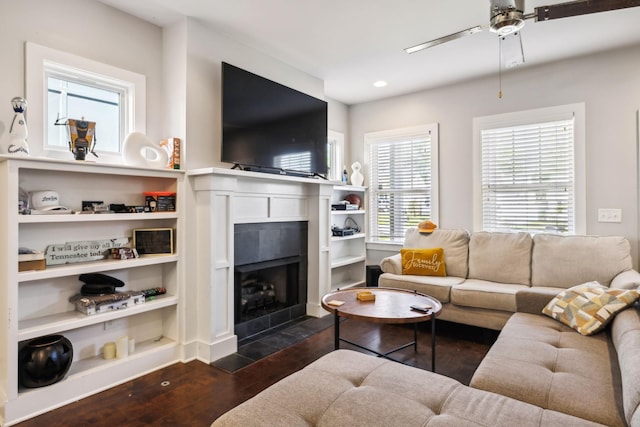 living room with dark wood finished floors, ceiling fan, a tile fireplace, and recessed lighting