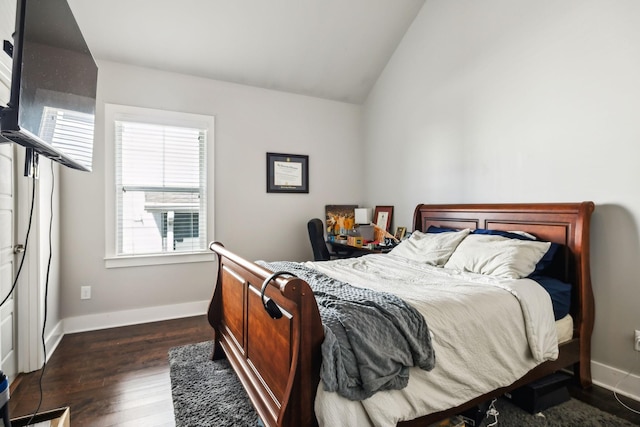 bedroom with dark wood finished floors, vaulted ceiling, and baseboards