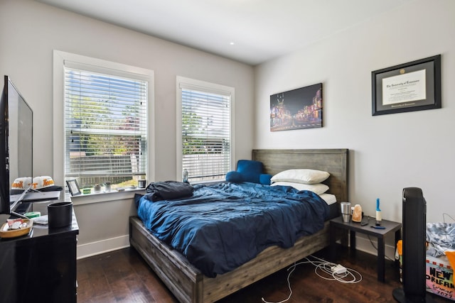 bedroom featuring baseboards and wood-type flooring