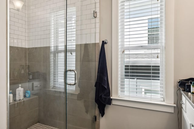 bathroom featuring vanity and a shower stall
