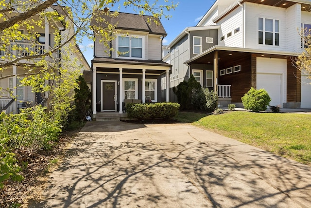 traditional-style home featuring a porch, an attached garage, and a front yard