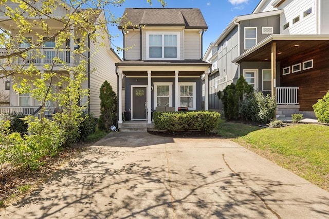 view of front of house with a shingled roof and covered porch