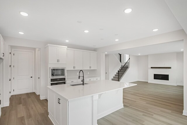 1714 Allwood Ave E, Murfreesboro, TN 37128 - kitchen with stainless steel appliances, a fireplace, white cabinets, and a sink