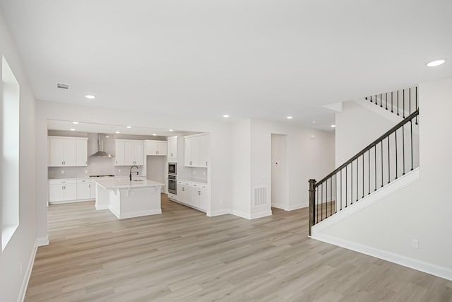 1714 Allwood Ave E, Murfreesboro, TN 37128 - unfurnished living room featuring light wood-style flooring, visible vents, and recessed lighting