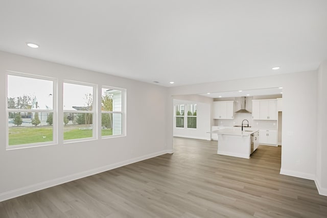 1714 Allwood Ave E, Murfreesboro, TN 37128 - unfurnished living room with a sink, baseboards, wood finished floors, and a healthy amount of sunlight