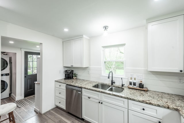 375 Mount Vernon Rd, Bethpage, TN 37022 - kitchen featuring light wood-type flooring, white cabinets, stacked washer / dryer, dishwasher, and a sink