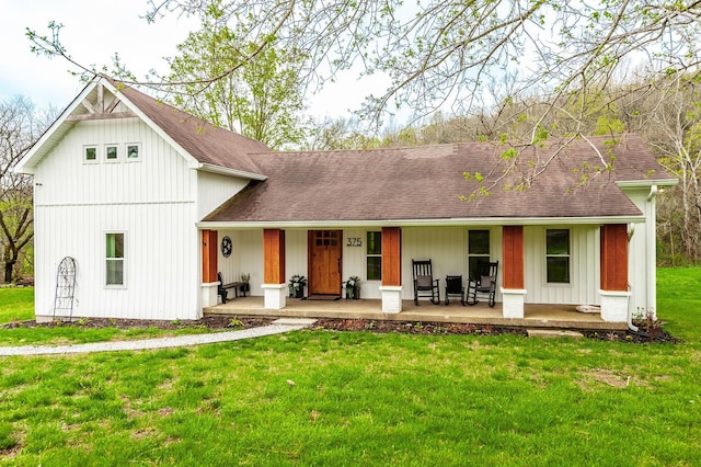 375 Mount Vernon Rd, Bethpage, TN 37022 - view of front of house featuring a porch, roof with shingles, board and batten siding, and a front lawn