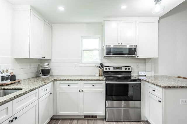 375 Mount Vernon Rd, Bethpage, TN 37022 - kitchen featuring light stone countertops, appliances with stainless steel finishes, and white cabinets