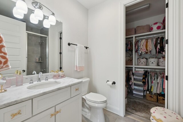 bathroom with toilet, a spacious closet, tile patterned floors, and a stall shower