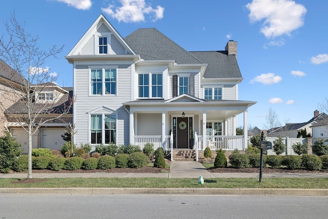 view of front of house featuring a chimney, a shingled roof, and covered porch