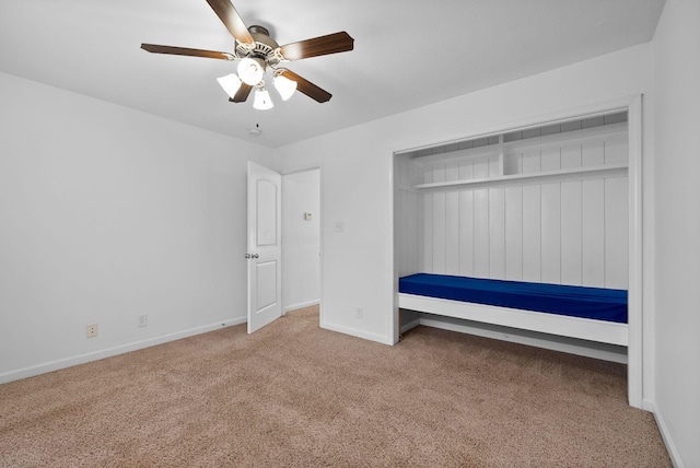 unfurnished bedroom with ceiling fan, baseboards, and carpet floors