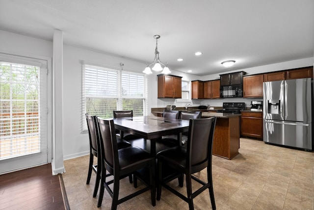 dining room featuring baseboards, plenty of natural light, and recessed lighting
