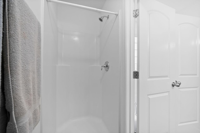 full bath with a shower stall
