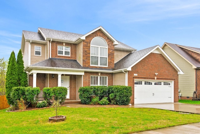 view of front facade featuring driveway, a front yard, a garage, a shingled roof, and covered porch