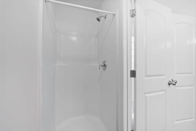 full bath with a shower stall