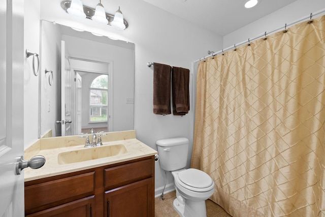 bathroom featuring toilet, vanity, a shower with shower curtain, and tile patterned flooring