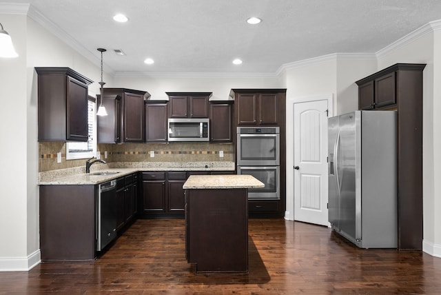 kitchen featuring stainless steel appliances, dark brown cabinetry, and a sink