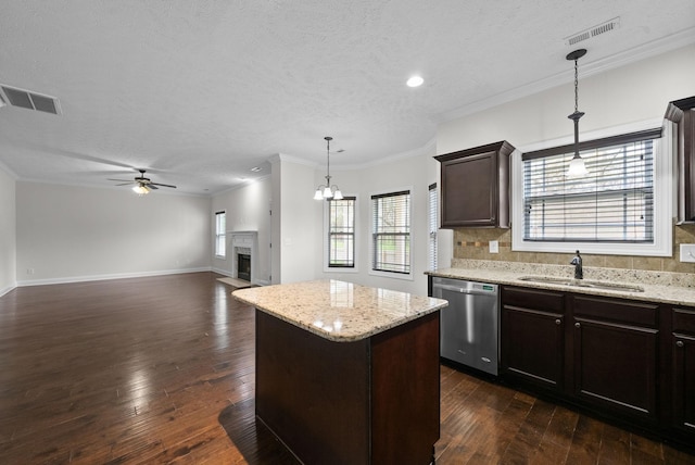 kitchen featuring a sink, visible vents, decorative backsplash, and dishwasher