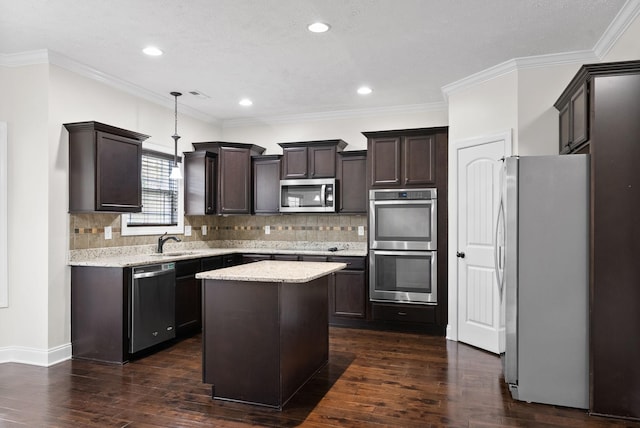 kitchen featuring a center island, a sink, appliances with stainless steel finishes, dark wood finished floors, and dark brown cabinets
