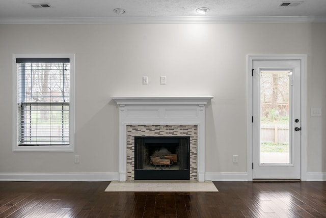 unfurnished living room with crown molding, a healthy amount of sunlight, and dark wood-style floors