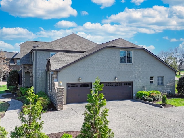 1496 Foxland Blvd, Gallatin, TN 37066 - view of side of property with roof with shingles, concrete driveway, a garage, and brick siding