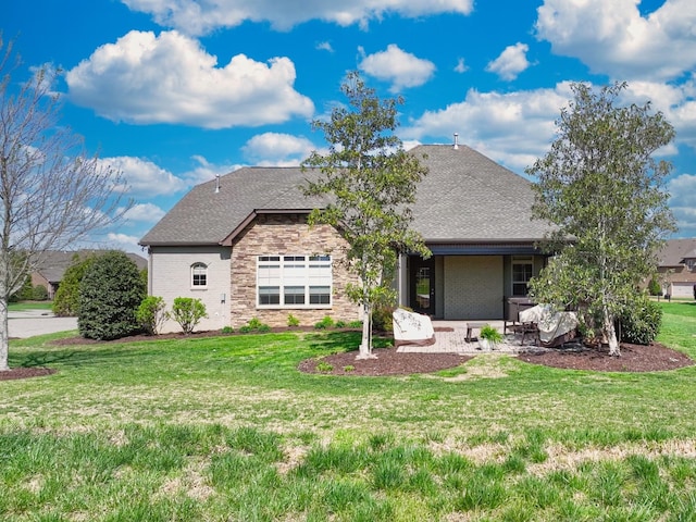 1496 Foxland Blvd, Gallatin, TN 37066 - view of front facade featuring a shingled roof, a front yard, and stone siding