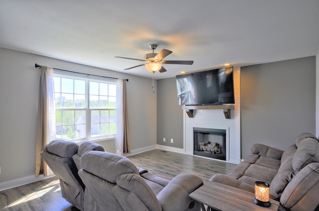 824 Crestone Ln, Clarksville, TN 37042 - living area with wood finished floors, a large fireplace, baseboards, and a ceiling fan
