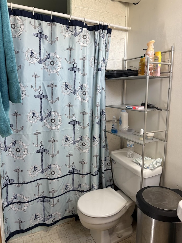 full bathroom with tile patterned floors, toilet, and a shower with shower curtain