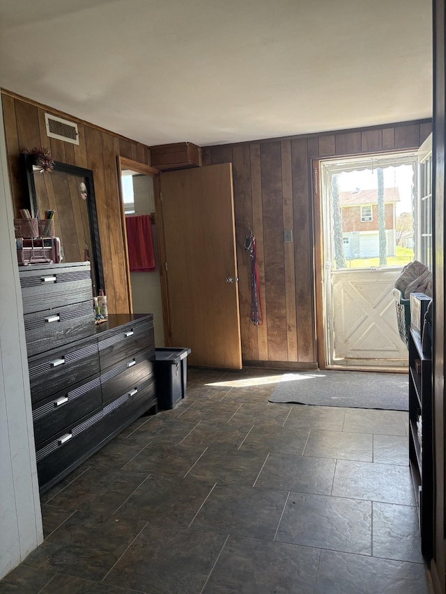 interior space featuring wooden walls and visible vents