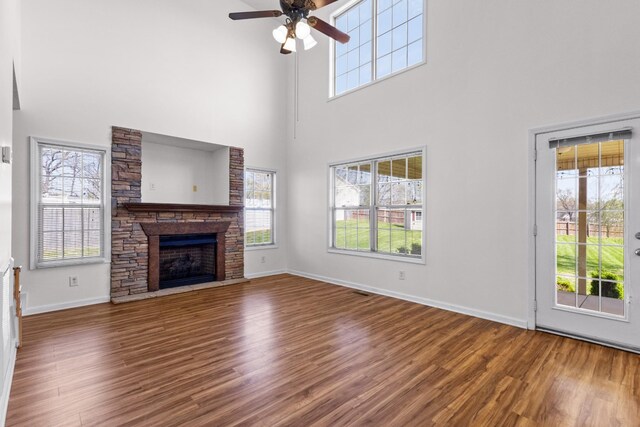 unfurnished living room featuring wood finished floors, a ceiling fan, and plenty of natural light